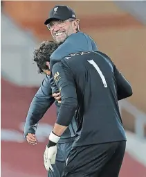  ?? PHIL NOBLE THE ASSOCIATED PRESS ?? Liverpool manager Jurgen Klopp, pictured back, celebrates with goalkeeper Alisson after an English Premier League soccer match against Crystal Palace at Anfield Stadium.
