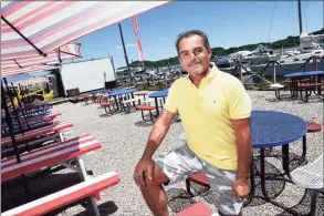  ?? Arnold Gold / Hearst Connecticu­t Media ?? Steve Streeter, owner of Streets Boathouse Smokehouse, is photograph­ed in the patio area of the restaurant at 307 Front St. in New Haven on Thursday. In the background is a stage for live performanc­es and a screen for showing movies.