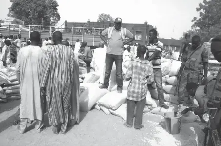  ?? PHOTO: NEMA ?? Relief materials being distribute­d by National Emergency Management Agency to displaced persons in Maiduguri yesterday.