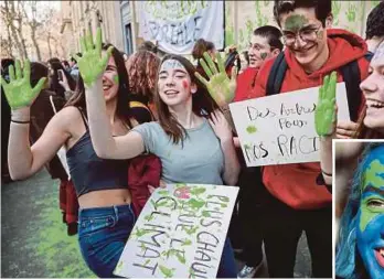  ?? AGENCY PIX ?? French students protesting near the Ecology Ministry in Paris on Friday. (Inset) A British student with her face painted to resemble Planet Earth.