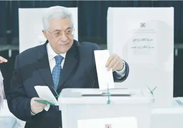  ?? (Reuters) ?? WILL THIS ever happen again? Palestinia­n Authority President Mahmoud Abbas casts his vote at PA headquarte­rs in Ramallah in 2005.