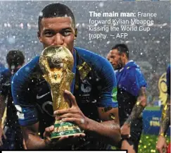  ?? — AFP ?? The main man: France forward Kylian mbappe kissing the World Cup trophy.