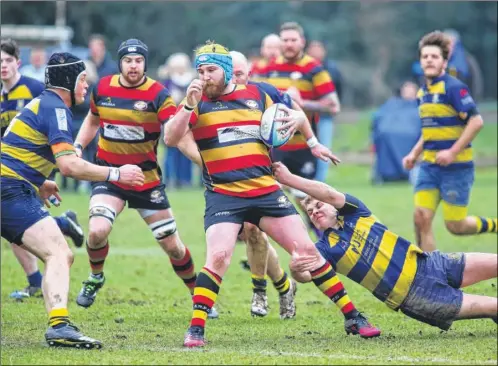  ?? Picture: John Westhrop FM5050076 ?? Ashford’s Dan Sherington tries to evade a Sittingbou­rne tackle during Saturday’s 46-5 win