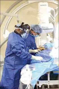  ?? THE CALIFORNIA­N, FILE ?? Adventist Health Radiologic Technologi­st Paul Conton, left, assists Dr. Viral Mehta while using biplane imaging technology in the Bakersfiel­d hospital’s cath lab in 2021.