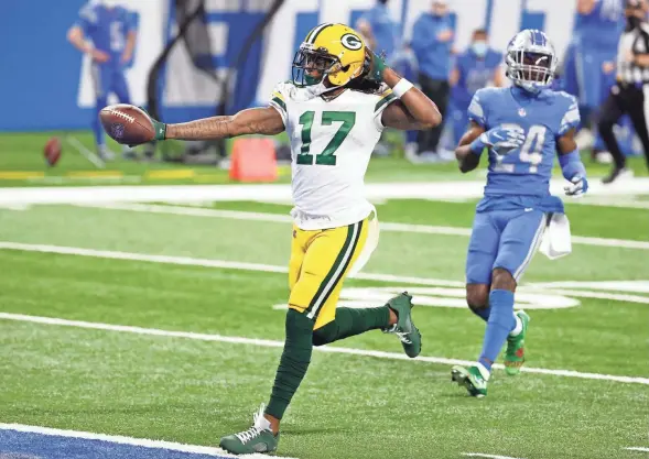  ?? ASSOCIATED PRESS ?? Packers wide receiver Davante Adams celebrates as he scores a touchdown in front of Lions cornerback Amani Oruwariye in the first half Sunday.