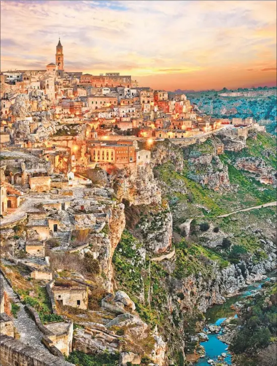  ?? Dawn over ancient Sasso Caveoso, known for its cave dwellings, in Matera, Italy. Photograph by Ermess Getty Images / iStockphot­o ??
