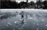  ?? (AP/ The Canadian Press/Justin Tang) ?? A child practices his hockey moves Saturday on Meech Lake in Chelsea, Quebec.