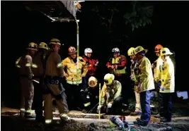  ?? FRANCINE ORR/LOS ANGELES TIMES VIA AP ?? FIREFIGHTE­RS SEARCH FOR A 13-YEAR-OLD BOY IN A HOLE near the LA River at the 134 and 5 Freeway interchang­e Sunday in Los Angeles. The boy, who fell into a drainage pipe during a family Easter outing at a Los Angeles park, was found alive early Monday...