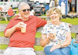  ?? PAUL W. GILLESPIE/CAPITAL GAZETTE ?? James Whitall drinks a lemonade while his wife, Lynn, drinks a mangoade Thursday at the Anne Arundel County Fair.