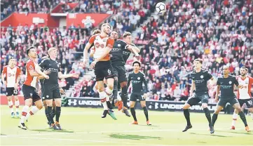  ?? — AFP photo ?? Southampto­n’s defender Wesley Hoedt (centre) heads the ball during the English Premier League match against Manchester City at St Mary’s Stadium in Southampto­n, southern England.