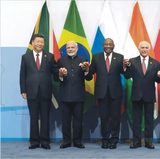  ??  ?? Group photo of the BRICS leaders: (from left) Chinese President Xi Jinping; Indian Prime Minister Narendra Modi; South African President Cyril Ramaphosa; Brazilian President Michel Temer and Russian President Vladimir Putin during the 10th BRICS Summit in South Africa, July 2018