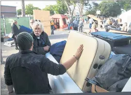  ?? PHOTOS BY KARL MONDON — STAFF PHOTOGRAPH­ER ?? Charles Nelson gets help packing up his belongings at Hope Village homeless encampment Monday morning in the final hours before eviction from its unsanction­ed location on Ruff Drive in San Jose. The camp was relocated to a temporary location down the block on Ruff Drive to the offices of the SEIU local.