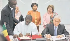  ??  ?? Idris (seated right) signing the MoU with Professor Mary Teuw Niane witnessed by Education Ministry secretary general Tan Sri Dr Noorul Ainur Mohd Nur (standing right) and Senegal ambassador to Malaysia Dr Adrienne Diop (second right) in Putrajaya. —...