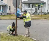  ?? MICHAEL SWENSEN/GETTY ?? EPA contractor­s maintain air monitoring systems Friday in East Palestine, Ohio. A Norfolk Southern Railways train with toxic chemicals derailed Feb. 3.