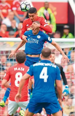  ?? AFP ?? Manchester United’s English defender Chris Smalling (centre, top) rises above Leicester City’s Algerian striker Islam Slimani (centre, bottom) to win a header during their English Premier League match at Old Trafford in Manchester, on Saturday....