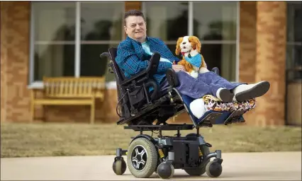  ?? JAN-MICHAEL STUMP— TRAVERSE CITY RECORD-EAGLE VIA AP ?? Mary Ecker holds “Tigger,” one of the 20robotic dogs and cats purchased by Grandvue Medical Care Facility in East Jordan, Mich. through a statewide initiative to help alleviate isolation during COVID.