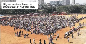  ??  ?? Migrant workers line up to board buses in Mumbai, India