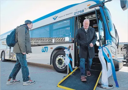  ?? PETER LEE WATERLOO REGION RECORD ?? Riders check out one of nine new Ion express buses in Cambridge Monday. Until the LRT launch, Ion buses will ply various Cambridge routes.