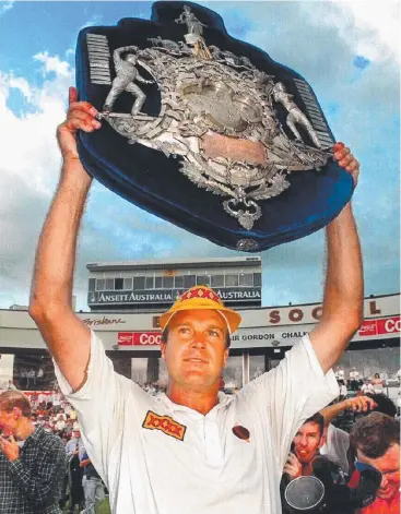  ??  ?? TOPS: Carl Rackemann holds aloft Queensland's first Sheffield Shield after beating SA at the Gabba.