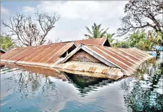  ?? SUPPLIED ?? Floodwater­s reach the rooftops of abandoned homes in Srekor village. Villagers there have made demands for public facilities.