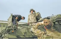  ?? LAETITIA VANCON THE NEW YORK TIMES ?? During NATO exercises, maintenanc­e personnel in Frankenber­g, Germany, check systems of vehicles in a convoy heading toward the Polish border earlier this month. Russia’s war in Ukraine infuses almost every aspect of NATO’s annual exercises, making the proceeding­s a preview of what a Great Power conflict could look like.