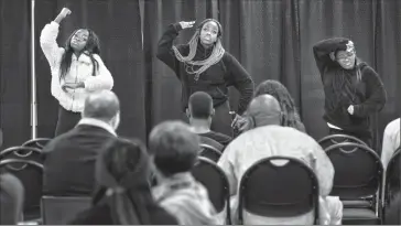  ?? @IMartensHe­rald Herald photo by Ian Martens ?? Amy Mpofu, Benny Amititi and Mauwa Washikala entertain with an African dance session Thursday as part of the wrap-up event for Black History Month at Lethbridge College.