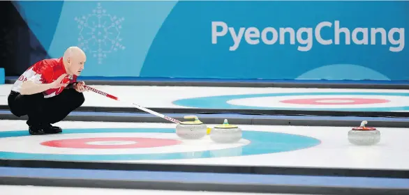  ?? NATACHA PISARENKO/THE ASSOCIATED PRESS ?? Skip Kevin Koe assesses things during Canada’s 5-3 win over Italy on Wednesday in Gangneung, South Korea.