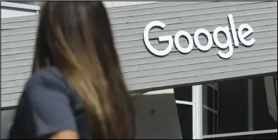  ?? ASSOCIATED PRESS ?? In this September 2019 file photo, a woman walks below a Google sign on the campus View, Calif. in Mountain