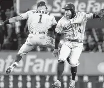  ?? GETTY IMAGES ?? Houston Astros teammates Carlos Correa, left, and George Springer celebrate their team's 8-3 win over the New York Yankees in Game 4 of the American League Championsh­ip Series Thursday at Yankee Stadium. The Toronto Blue Jays have shown an interest in Springer, who is a free agent.