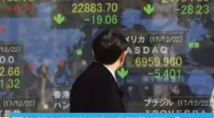  ??  ?? TOKYO: A man looks at an electronic stock board of a securities firm in Tokyo yesterday. — AP