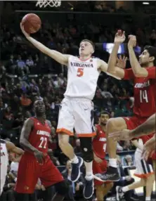  ?? FRANK FRANKLIN II - THE ASSOCIATED PRESS ?? Virginia’s Kyle Guy (5) drives past Louisville’s Anas Mahmoud (14) during the second half of an NCAA college basketball game in the quarterfin­al round of the Atlantic Coast Conference tournament Thursday, in New York. Virginia won 75-58.