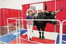  ?? Elizabeth Conley/Staff photograph­er ?? Elaine Wilmore of Cleburne poses for a photo with Tex on Thursday during the first day of the state GOP convention.