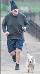  ??  ?? Levelling-up agenda: Boris Johnson out jogging with his dog Dilyn today