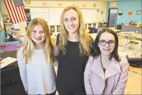  ??  ?? Hannah Stowell, right, and Alexandra Bender, left, students at Bethel Middle School, and teacher Caitlin Boles, center.