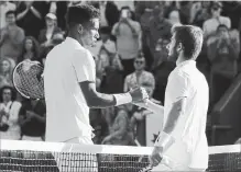  ??  ?? Canada’s Felix Auger-Aliassime, left, greets Corentin Moutet of France at the net after winning their second-round match Wednesday.