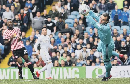  ??  ?? Sunderland keeper Lee Camp dives to make a save in Saturday’s 1-1 draw at Leeds. Picture by Frank Reid.