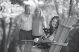  ?? STACEY WESCOTT/CHICAGO TRIBUNE ?? Sophia Pseno, 13, sits with her dog Eggsy, with her parents Steve and Carol in the background, outside their Inverness home on Aug. 5. Sophia and her mother have been reading and baking together over the summer.