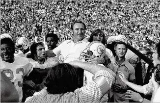  ?? AP FILE ?? Dolphins coach Don Shula is carried off the field after his team beat the Redskins 14-7 to complete an undefeated season in the Super Bowl in 1973. Shula, who is the NFL’s winningest coach, had previously lost two Super Bowls and an NFL Championsh­ip game. SUPER BOWL VII