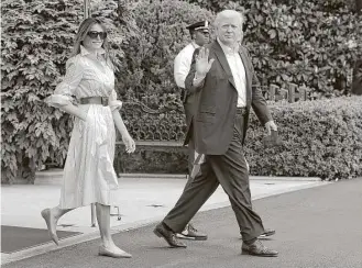  ?? Carolyn Kaster / Associated Press ?? President Donald Trump, Melania Trump, and their son Barron walk Saturday to board Marine One from the White House en route to Camp David, the government-owned retreat in Maryland.