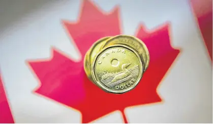  ?? MARK BLINCH ■ REUTERS FILE ?? The slumping Canadian dollar could have an impact on the Bank of Canada’s interest rate cuts.