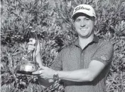  ?? JOHN RAOUX AP ?? Justin Thomas holds the trophy after winning The Players Championsh­ip by one shot over Lee Westwood.