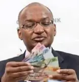  ??  ?? CBG Governor Patrick Njoroge displays the new notes in 2019. Under CBK’s initiative, individual­s and companies could take a repayment holiday, lengthen the tenure of their loans.