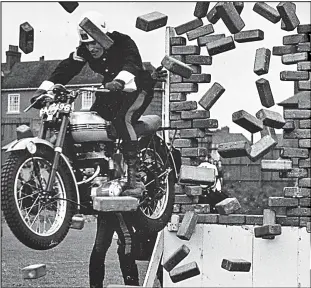  ??  ?? Smashing show: A White Helmet blasts through a brick wall in 1953