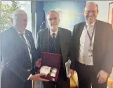  ?? ?? Cyprus Turkish Municipali­ties Union chairman Mahmut Özcınar, left, presenting a gift to Council of Europe officials Marc Cools and Bernd Vöhringer