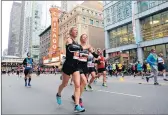  ?? ANTONIO PEREZ/CHICAGO TRIBUNE ?? Runners on State Street during the 2019 Chicago Marathon. The 2020 marathon was canceled due to COVID-19.