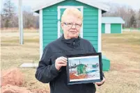  ??  ?? Jean Cahill at Jacques Cartier Provincial Park near Alberton, P.E.I. The beach shacks (in the framed picture) were damaged by storm surges. The original cottages, located nearby, have been relocated as land they once sat on is now underwater.