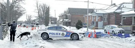  ?? CLIFFORD SKARSTEDT/EXAMINER ?? City police Const. Sam McCullum and police dog Hal investigat­e the crime scene on Dalhousie St. on Wednesday after Paul Atchison, 43, of Stewart St., was stabbed to death early Wednesday morning. Bryan Townson, 34, of Stewart St., has been charged with...