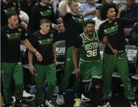  ?? REBECCA BLACKWELL — THE ASSOCIATED PRESS ?? Celtics players cheer during the second half of Game 4 during the Eastern Conference finals against the Heat on Tuesday in Miami.