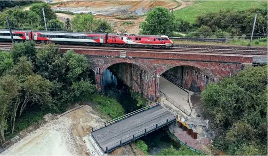  ?? Paul Clark ?? On August 28, Class 91 No. 91130 propels the 1A26 11.15 Leeds to King's Cross LNER service over the River Witham at Saltersfor­d, near Grantham. Substantia­l foundation­s have been cast to support the bridge deck at the bottom of the picture that is part of the evidently substantia­l haul road to be used to construct the A52 Grantham Southern Relief Road.