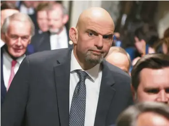  ?? ALEX WONG/GETTY ?? Sen. John Fetterman, D-Pa., walks through the Statuary Hall of the U.S. Capitol prior to President Joe Biden’s State of the Union address Tuesday in Washington, DC.